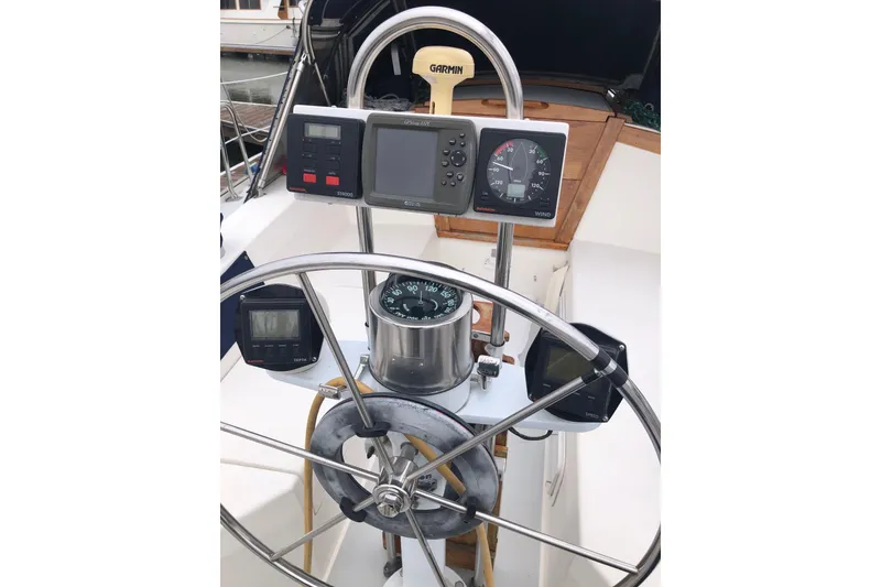 Slide: The Image of Steering wheel and navigation instruments on a 1992 Catalina 34 sailboat. - 16