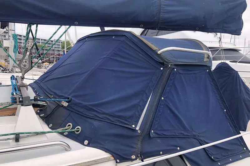 Slide: The Image of 1992 Catalina 34 sailboat with blue canvas cover and rigging details. - 18