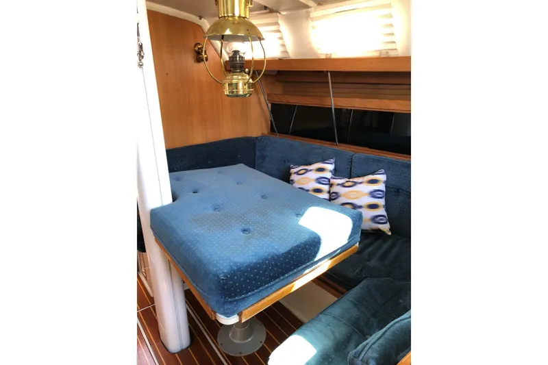 Slide: The Image of Cozy interior of 1992 Catalina 34 sailboat with blue seating and decorative pillows. - 4