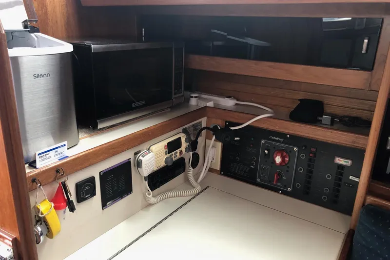 Slide: The Image of 1992 Catalina 34 yacht interior with control panel, microwave, and Silonn appliance. - 5
