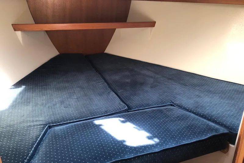 Slide: The Image of Interior cabin of a 1992 Catalina 34 sailboat with blue cushions. - 6