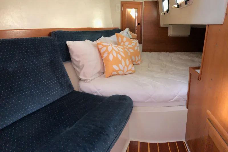 Slide: The Image of Cozy interior of a 1992 Catalina 34 sailboat with plush seating and decorative pillows. - 7
