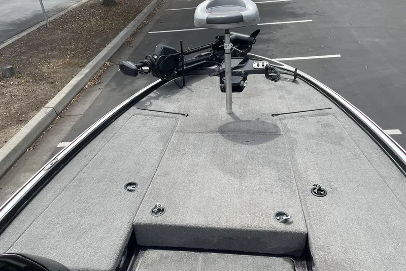 Slide: The Image of 2013 Nitro Z-8 boat deck with trolling motor in a parking lot. - 11