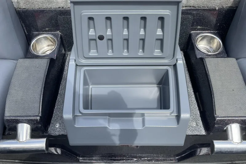Slide: The Image of Open storage compartment in a 2013 Nitro Z-8 boat, flanked by cup holders. - 13