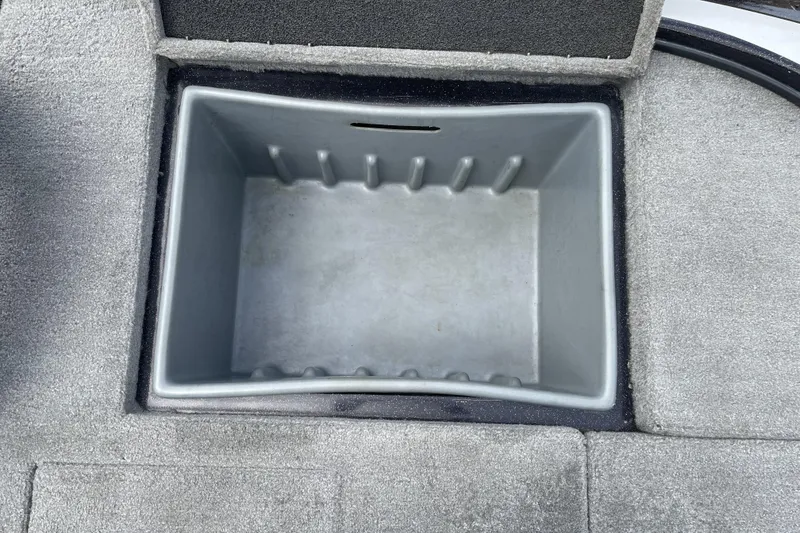 Slide: The Image of Empty storage compartment in a 2013 Nitro Z-8 boat, featuring a gray interior. - 17