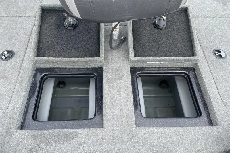 Slide: The Image of 2013 Nitro Z-8 boat storage compartments with gray carpet and seat detail. - 20