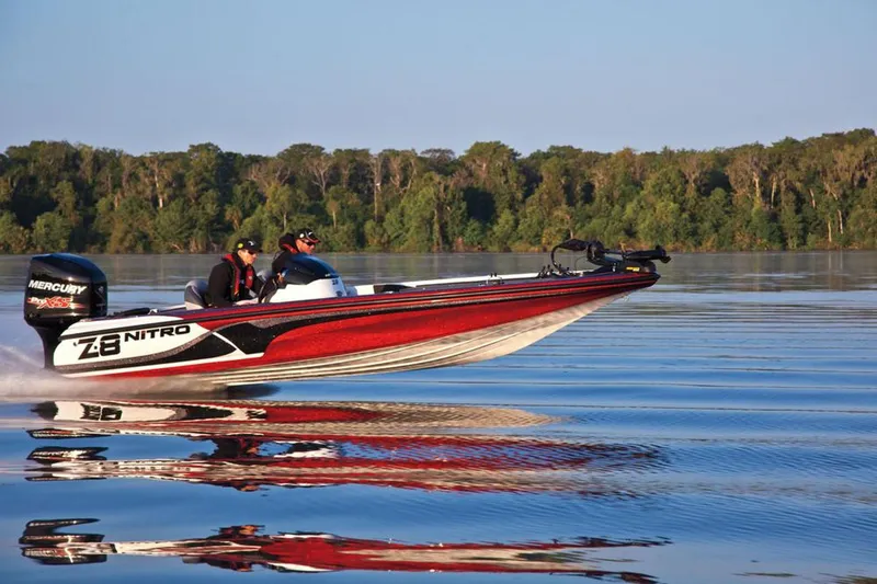 Slide: The Image of Manufacturer Provided Image: 2013 Nitro Z-8 boat speeding on a calm lake with lush green forest backdrop. - 31