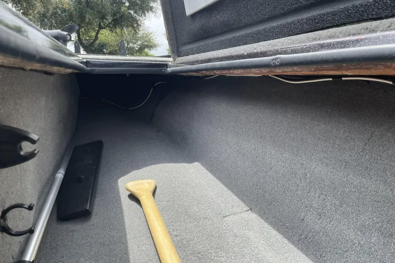 Slide: The Image of Interior view of a 2013 Nitro Z-8 boat storage compartment with a wooden paddle. - 8