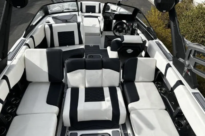 Slide: The Image of 2025 Malibu Wakesetter 23 MXZ interior with luxurious black and white seating. - 2