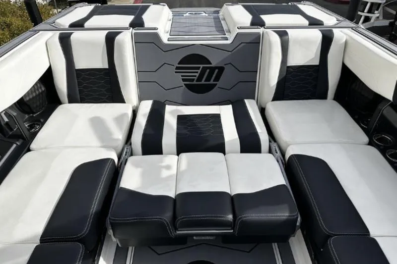 Slide: The Image of Luxurious interior of 2025 Malibu Wakesetter 23 MXZ boat with stylish black and white seating. - 3