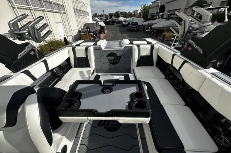 Slide: The Image of 2025 Malibu Wakesetter 23 MXZ interior with sleek seating and table setup. - 4