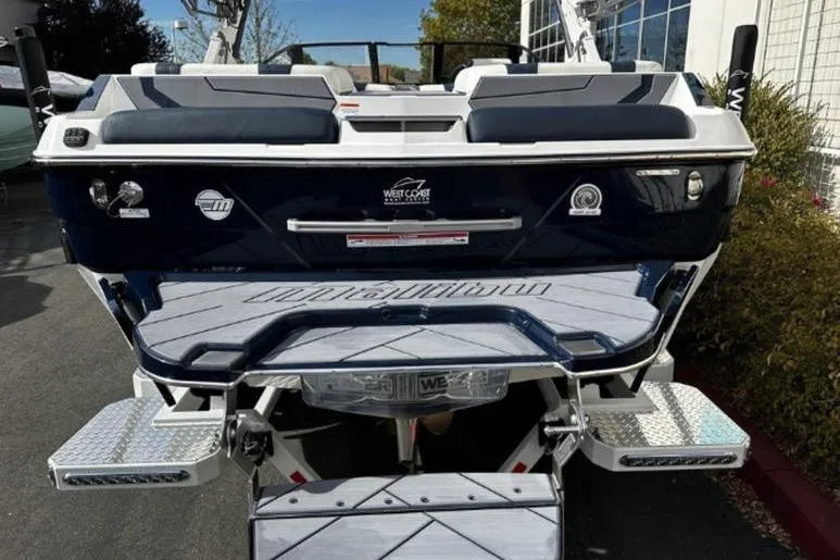 Slide: The Image of 2025 Malibu Wakesetter 23 MXZ boat rear view with swim platform and seating. - 5