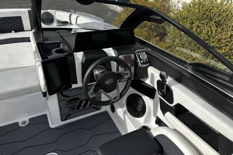 Slide: The Image of 2025 Malibu Wakesetter 23 MXZ boat interior with modern steering and dashboard controls. - 7
