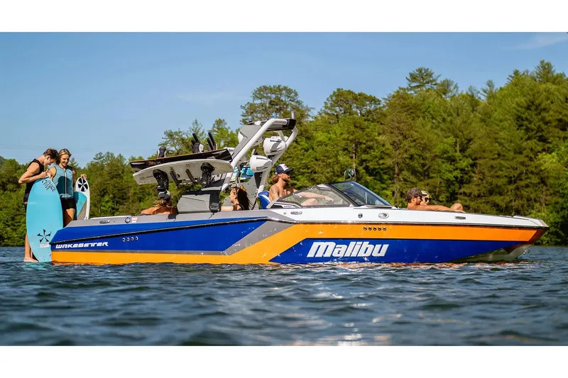 Slide: The Image of Manufacturer Provided Image: 2025 Malibu Wakesetter 23 MXZ on a lake with people enjoying water activities. - 8