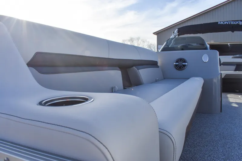 Slide: The Image of 2025 Montego Bay 90HP C8520 STD Cruise Pontoon interior with plush seating and cup holder. - 13