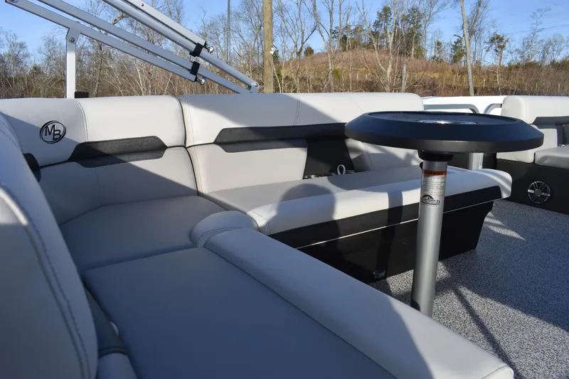 Slide: The Image of 2025 Montego Bay 90HP C8520 STD Cruise Pontoon interior with plush seating and table. - 18