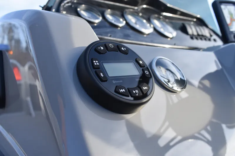 Slide: The Image of Close-up of 2025 Montego Bay 90HP C8520 STD Cruise Pontoon dashboard controls. - 21
