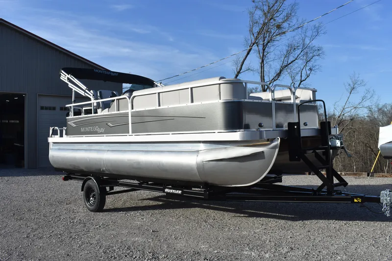 Slide: The Image of 2025 Montego Bay 90HP C8520 STD Cruise Pontoon on trailer, parked outdoors. - 7