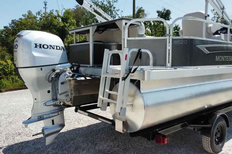 Slide: The Image of 2025 Montego Bay 90HP C8520 STD Cruise Pontoon with Honda engine, parked on gravel. - 9
