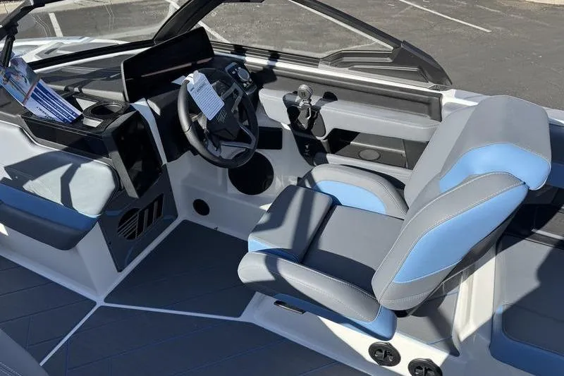 Slide: The Image of 2025 Malibu Wakesetter 26 LSV boat interior with modern dashboard and seating. - 7