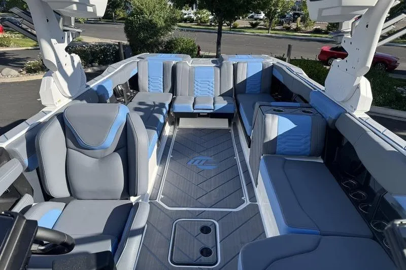 Slide: The Image of 2025 Malibu Wakesetter 26 LSV interior with sleek gray and blue seating design. - 8
