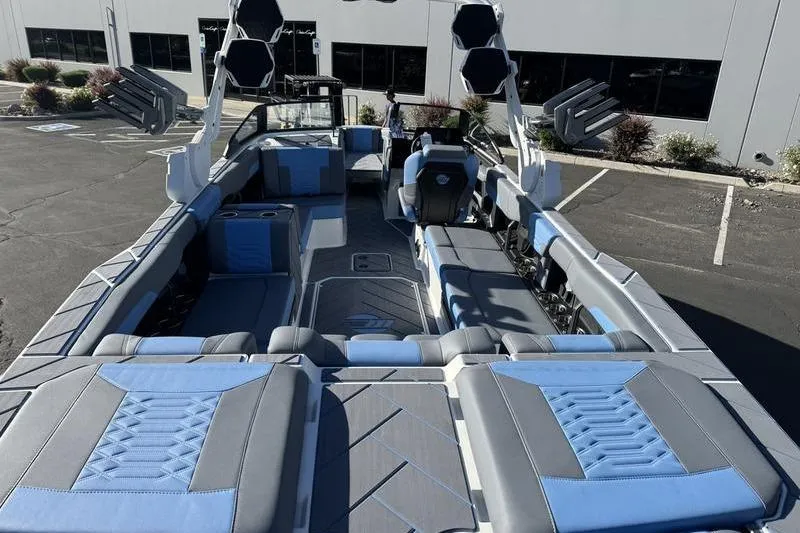 Slide: The Image of 2025 Malibu Wakesetter 26 LSV boat interior with blue and gray seating. - 9