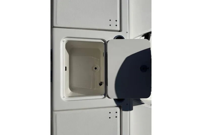 Slide: The Image of 2026 Bayliner Trophy T20CC boat storage compartment with open hatch, showcasing interior space. - 10