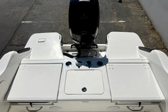 Slide: The Image of 2026 Bayliner Trophy T20CC boat stern with motor and storage compartments. - 11