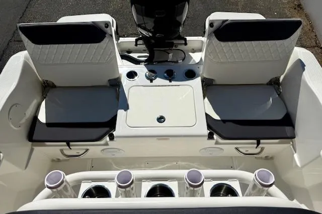 Slide: The Image of 2026 Bayliner Trophy T20CC boat interior with dual seats and fishing rod holders. - 12