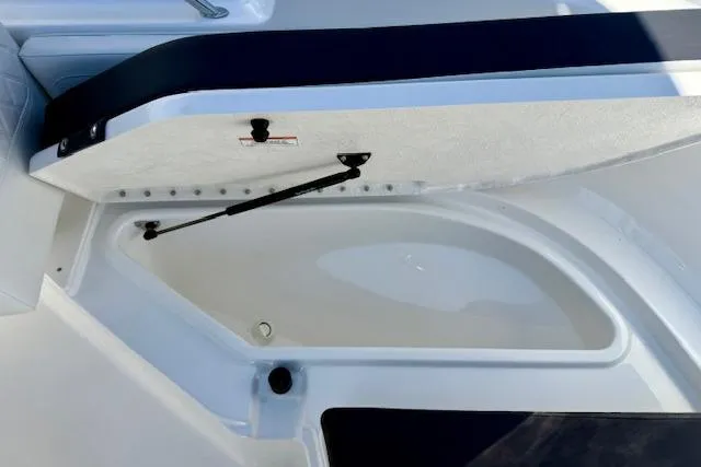 Slide: The Image of 2026 Bayliner Trophy T20CC boat storage compartment open, showcasing interior space. - 13