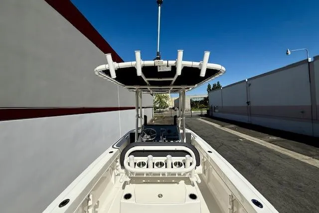 Slide: The Image of 2026 Bayliner Trophy T20CC boat with T-top, docked in an urban setting. - 15