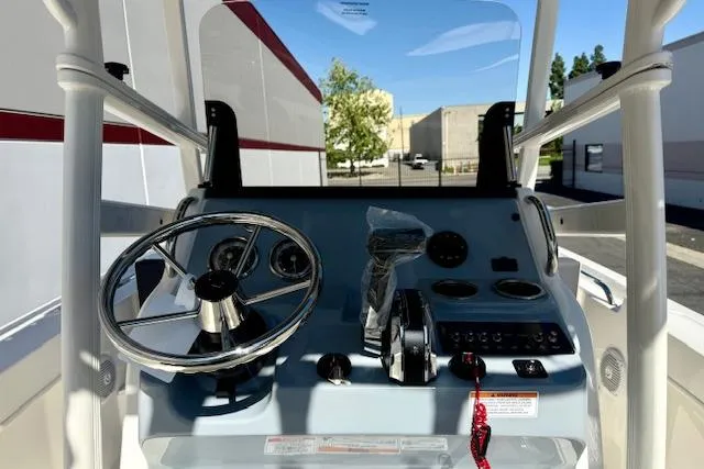 Slide: The Image of 2026 Bayliner Trophy T20CC boat dashboard with steering wheel and controls. - 17