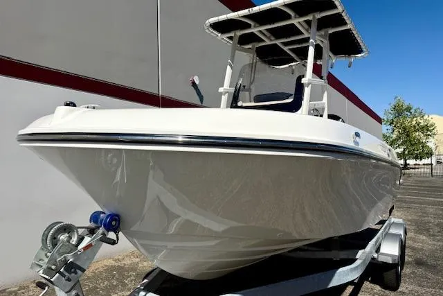 Slide: The Image of 2026 Bayliner Trophy T20CC boat on trailer, parked outdoors. - 20