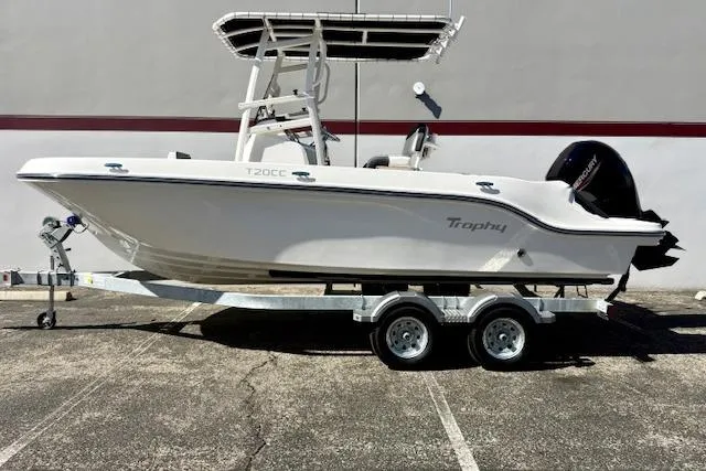 Slide: The Image of 2026 Bayliner Trophy T20CC boat on trailer, side view, parked outdoors. - 4