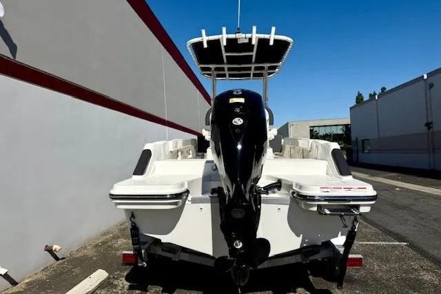 Slide: The Image of 2026 Bayliner Trophy T20CC boat, rear view, parked outdoors. - 5