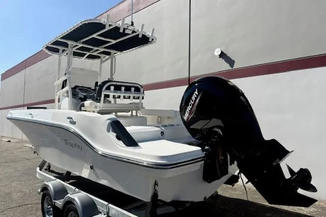 Slide: The Image of 2026 Bayliner Trophy T20CC boat with Mercury outboard motor on trailer, parked outdoors. - 6