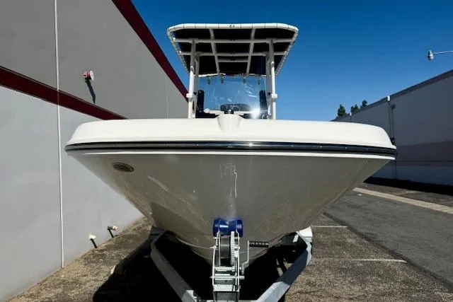 Slide: The Image of 2026 Bayliner Trophy T20CC boat on trailer, parked outdoors. - 7
