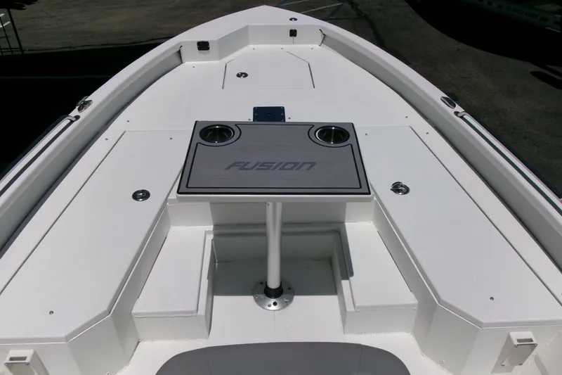 Slide: The Image of Avid 21 Fusion 2022 boat deck with table and cup holders. - 10