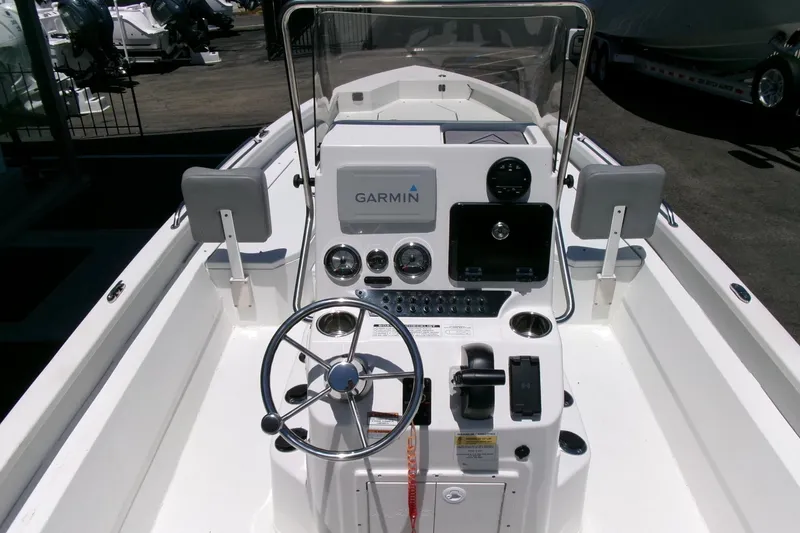 Slide: The Image of 2022 Avid 21 Fusion boat dashboard with Garmin navigation system and steering wheel. - 20