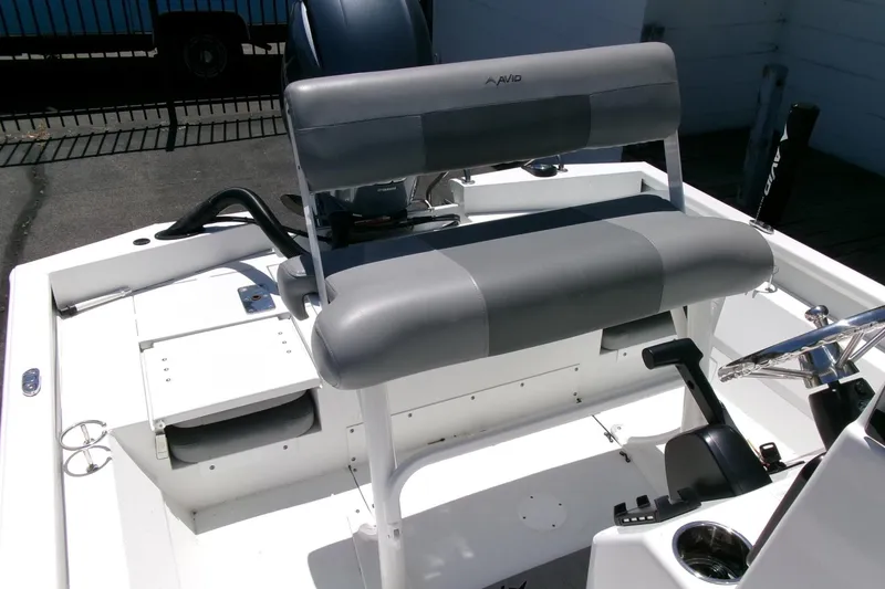 Slide: The Image of 2022 Avid 21 Fusion boat interior with gray seating and steering console. - 24