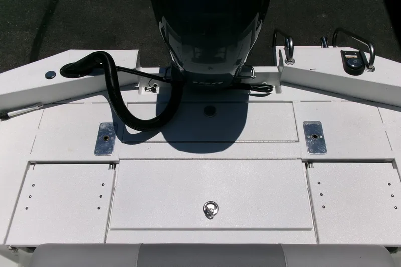 Slide: The Image of 2022 Avid 21 Fusion boat deck with motor and storage compartments. - 26