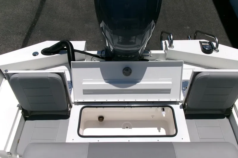 Slide: The Image of 2022 Avid 21 Fusion boat interior with open storage compartment and seating. - 27