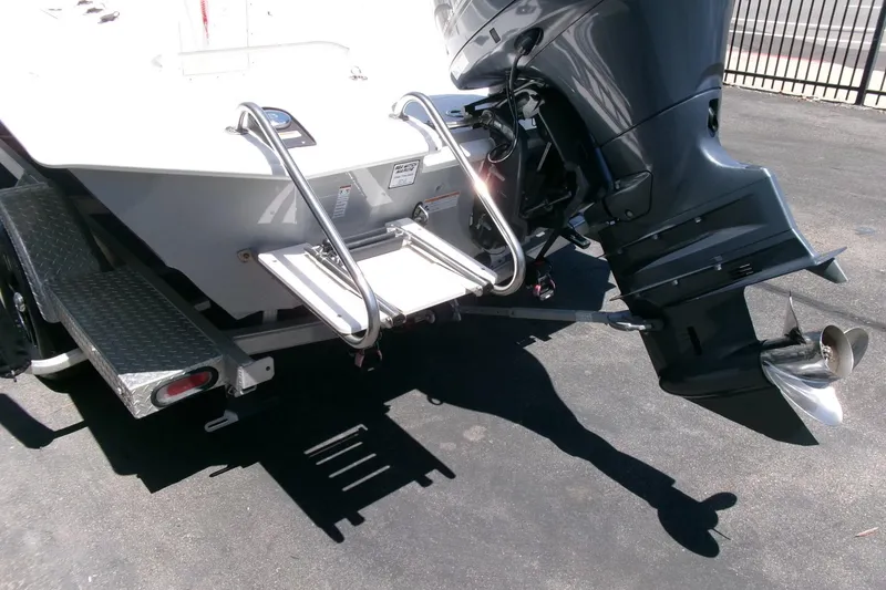 Slide: The Image of Avid 21 Fusion 2022 boat with outboard motor and swim ladder on trailer. - 28