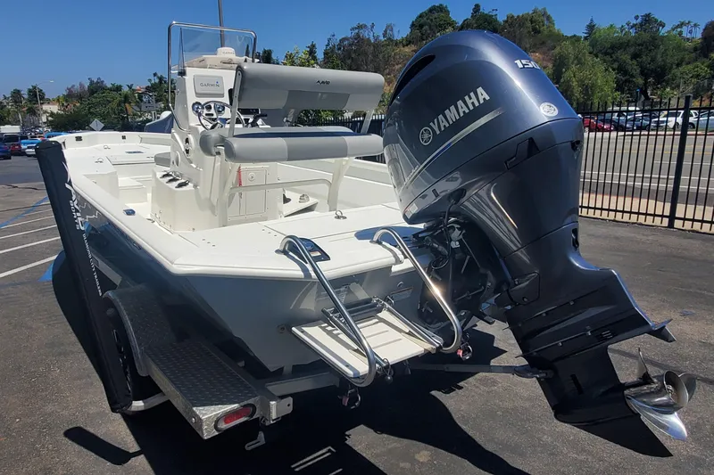 Slide: The Image of Avid 21 Fusion 2022 boat with Yamaha 150 engine, parked outdoors. - 3