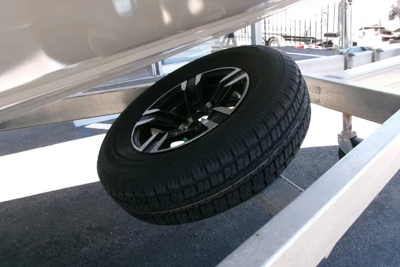 Slide: The Image of Spare tire mounted on an Avid 21 Fusion 2022 boat trailer. - 30