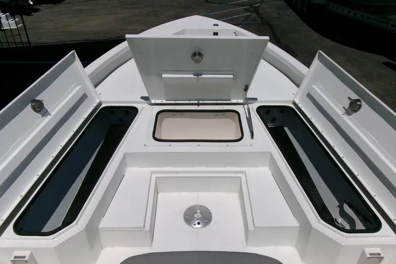Slide: The Image of Open storage compartments on a 2022 Avid 21 Fusion boat deck. - 7
