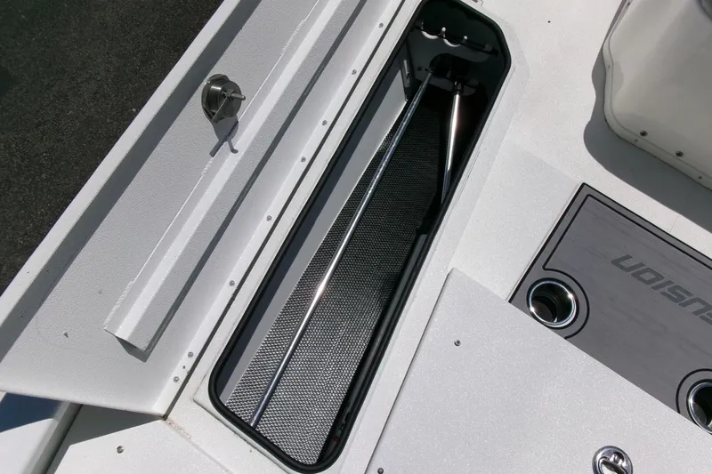 Slide: The Image of 2022 Avid 21 Fusion boat storage compartment with sleek design and metallic accents. - 8