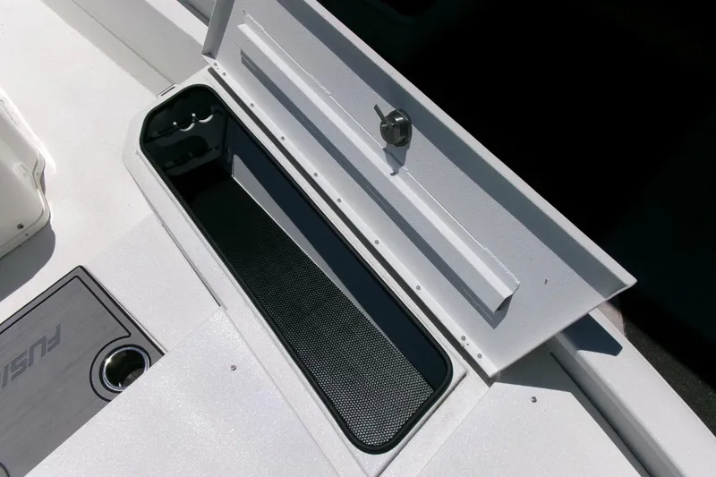 Slide: The Image of Open storage compartment on 2022 Avid 21 Fusion boat deck. - 9