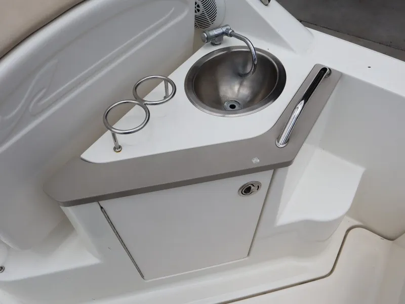 Slide: The Image of Sea Ray 240 Sundancer 2008 kitchenette with sink and cup holders. - 15