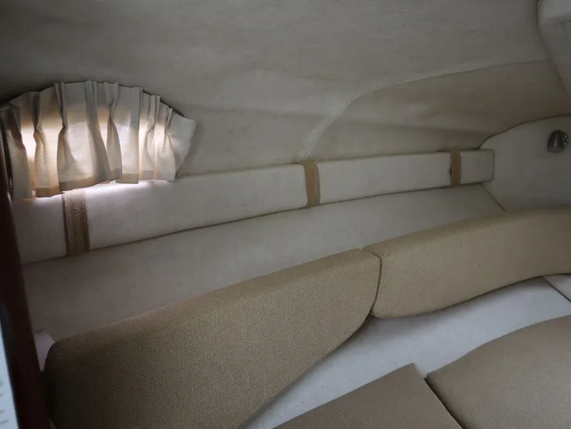 Slide: The Image of Interior of 2008 Sea Ray 240 Sundancer with beige upholstery. - 23